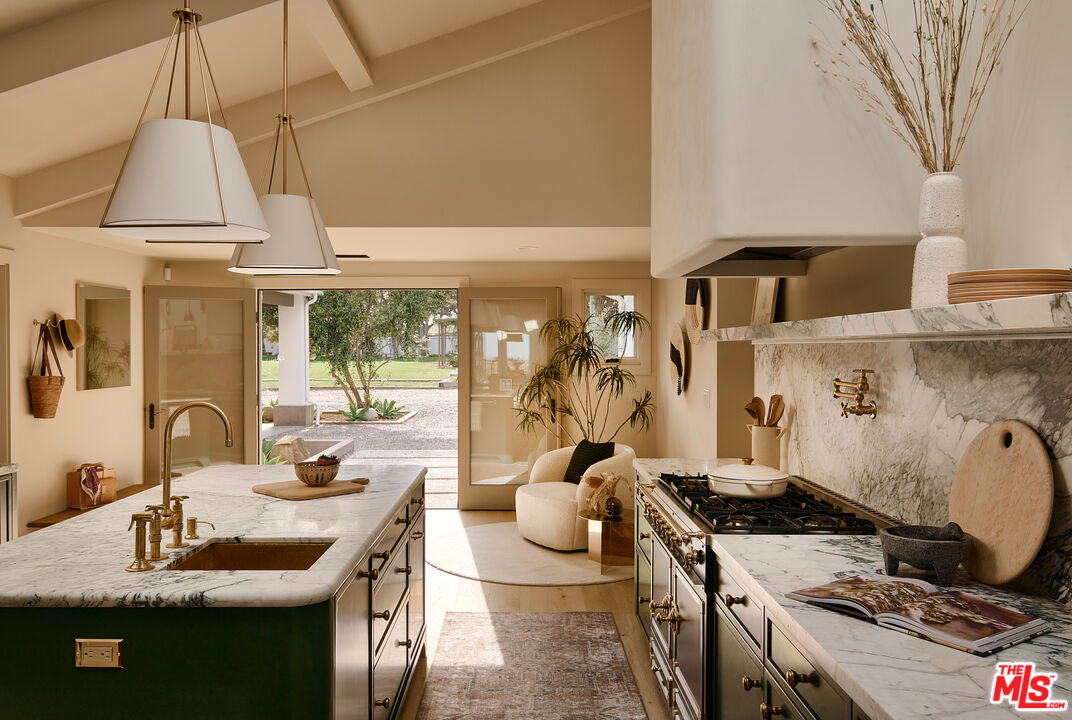 6930 Dume Drive Malibu, CA 90265 - Photo 6 of 34 a kitchen with sink stove and cabinets