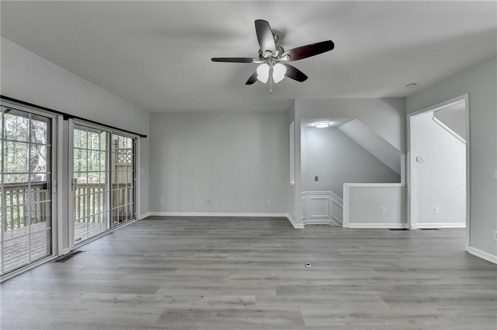 3977 Howell Park Road Duluth, GA 30096 - Photo 11 of 25 a view of an empty room with wooden floor and a window