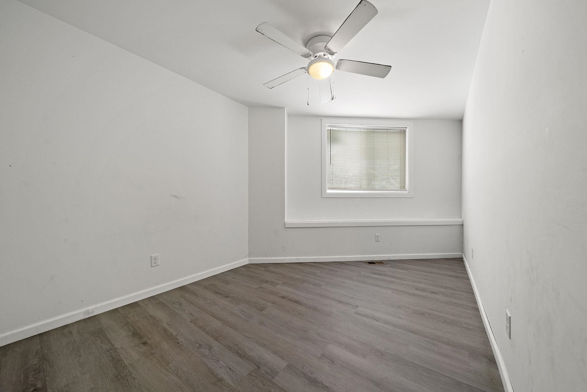 909-911 Ridge Avenue Rockford, IL 61103 - Photo 11 of 25 an empty room with wooden floor and windows