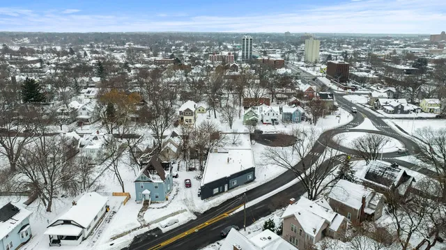 an aerial view of a house with swimming pool and mountain view