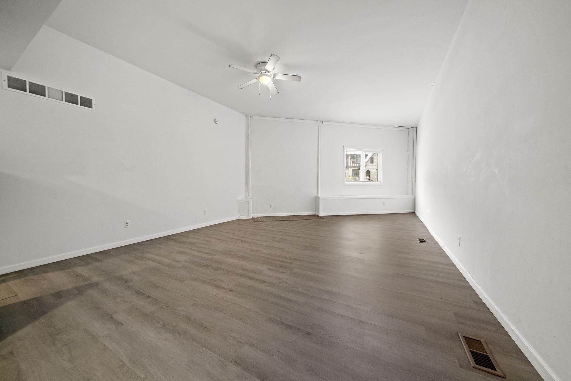 909-911 Ridge Avenue Rockford, IL 61103 - Photo 9 of 25 an empty room with wooden floor and windows