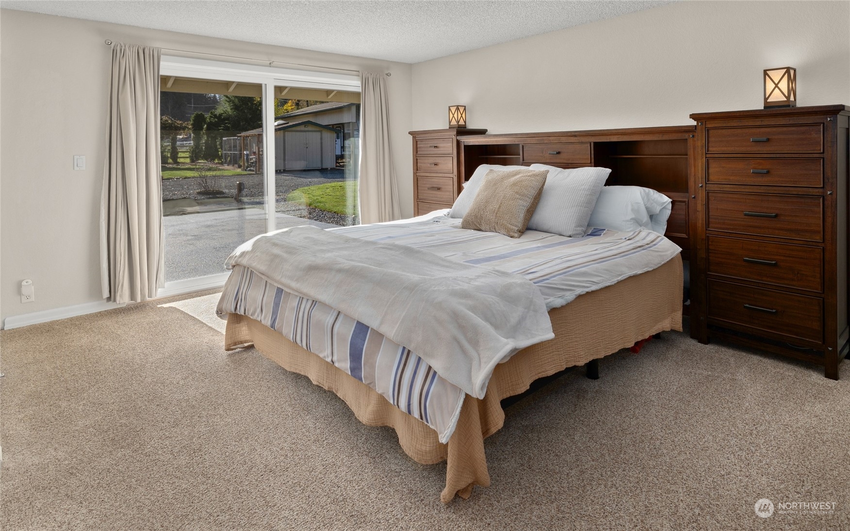 26417 Southeast 200th Street Maple Valley, WA 98038 - Photo 17 of 38 a bed sitting in a bedroom next to a window