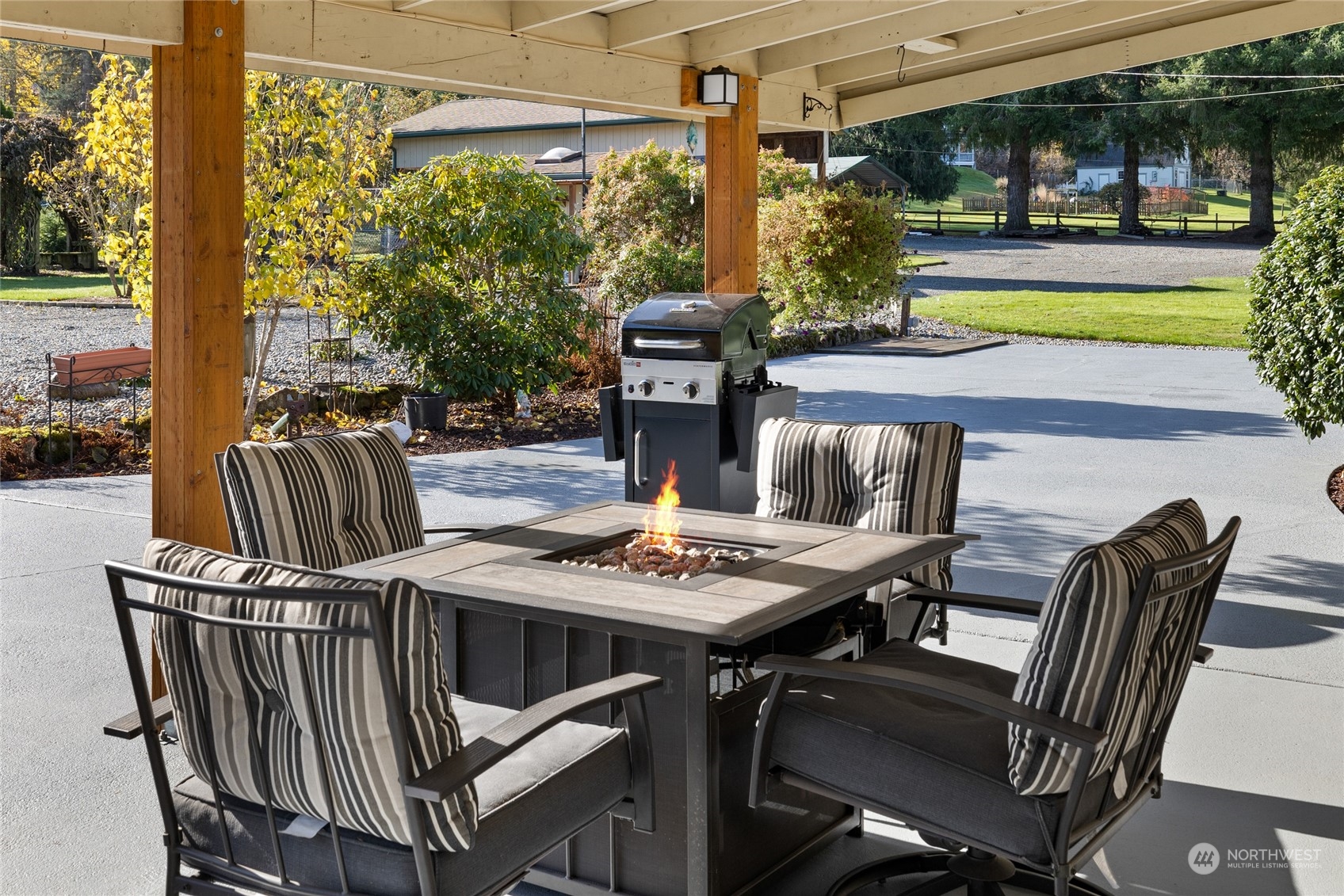 26417 Southeast 200th Street Maple Valley, WA 98038 - Photo 5 of 38 a view of a patio with table and chairs and potted plants