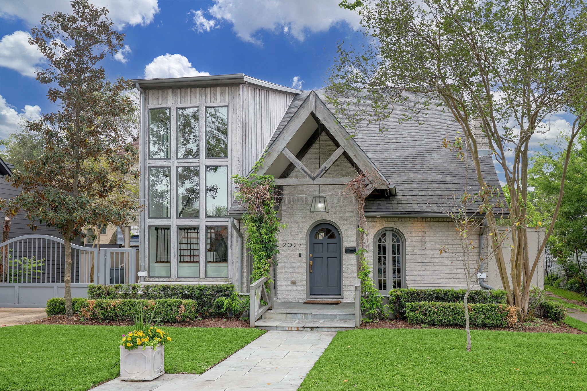 a front view of a house with a yard and fountain