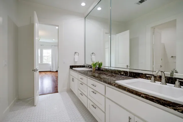 an empty room with wooden floor and window