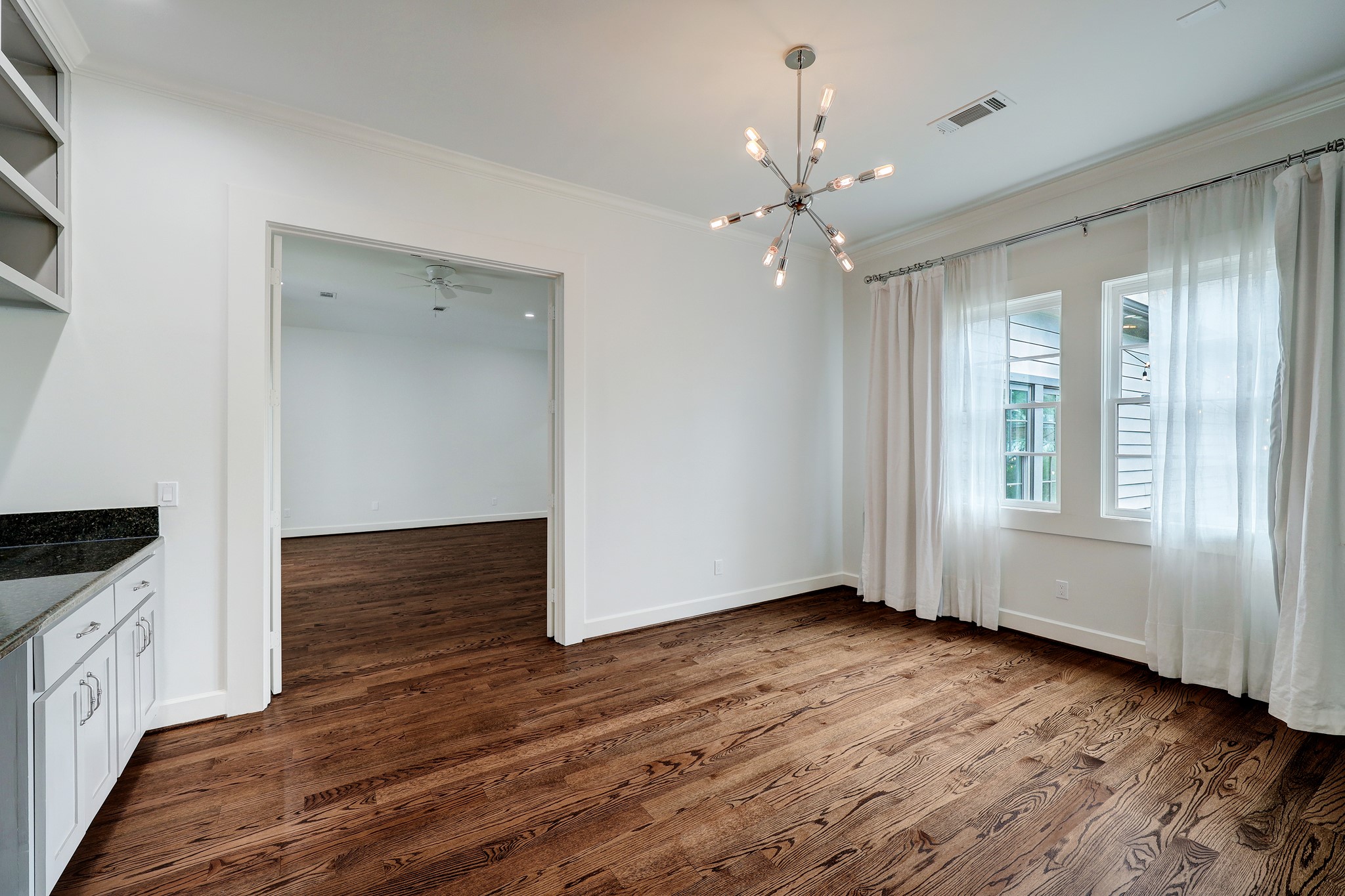 2027 Branard Street Houston, TX 77098 - Photo 26 of 36 a view of an empty room with wooden floor and a window