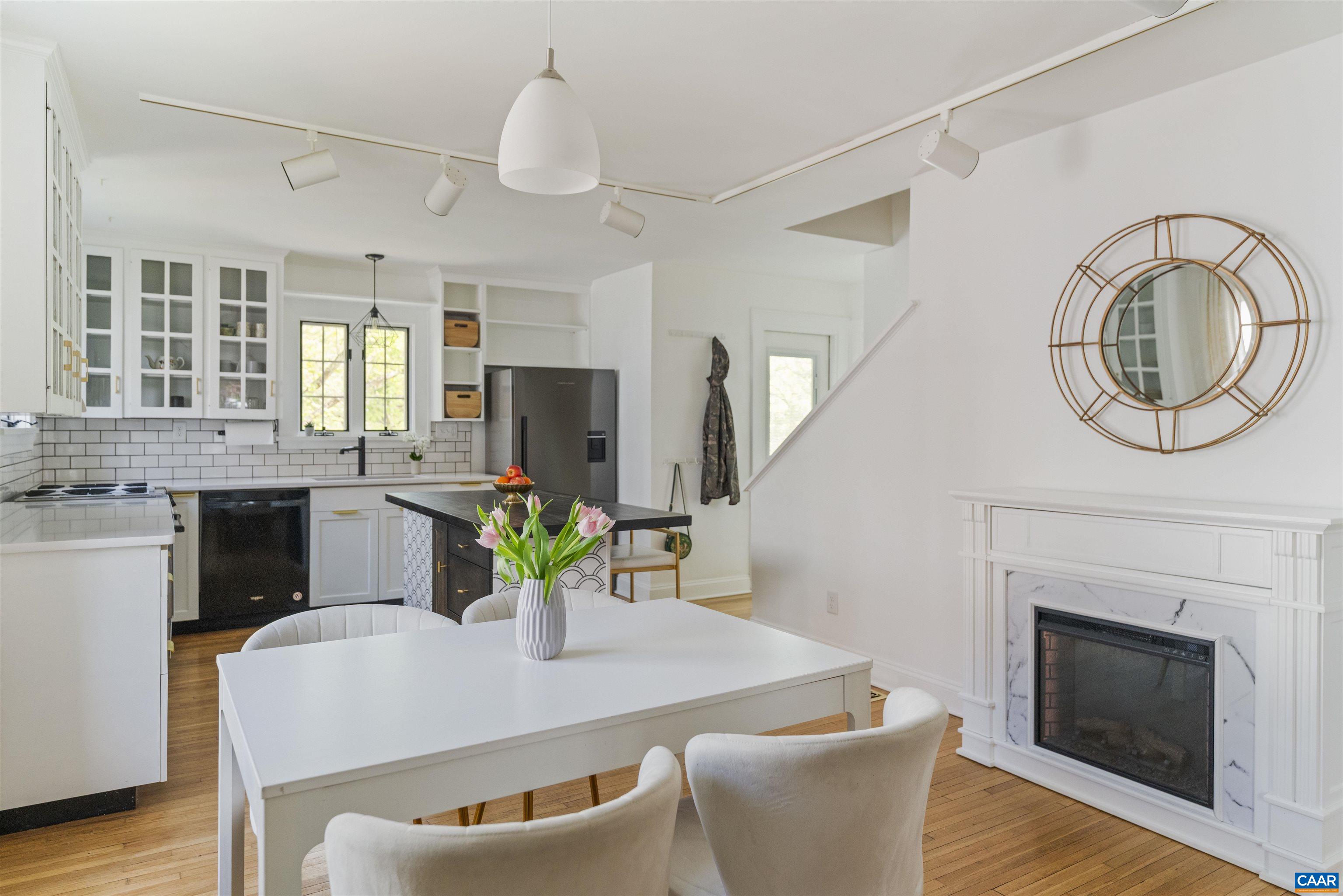 738 Lexington Avenue Charlottesville, VA 22902 - Photo 11 of 34 a living room with furniture a fireplace and a chandelier