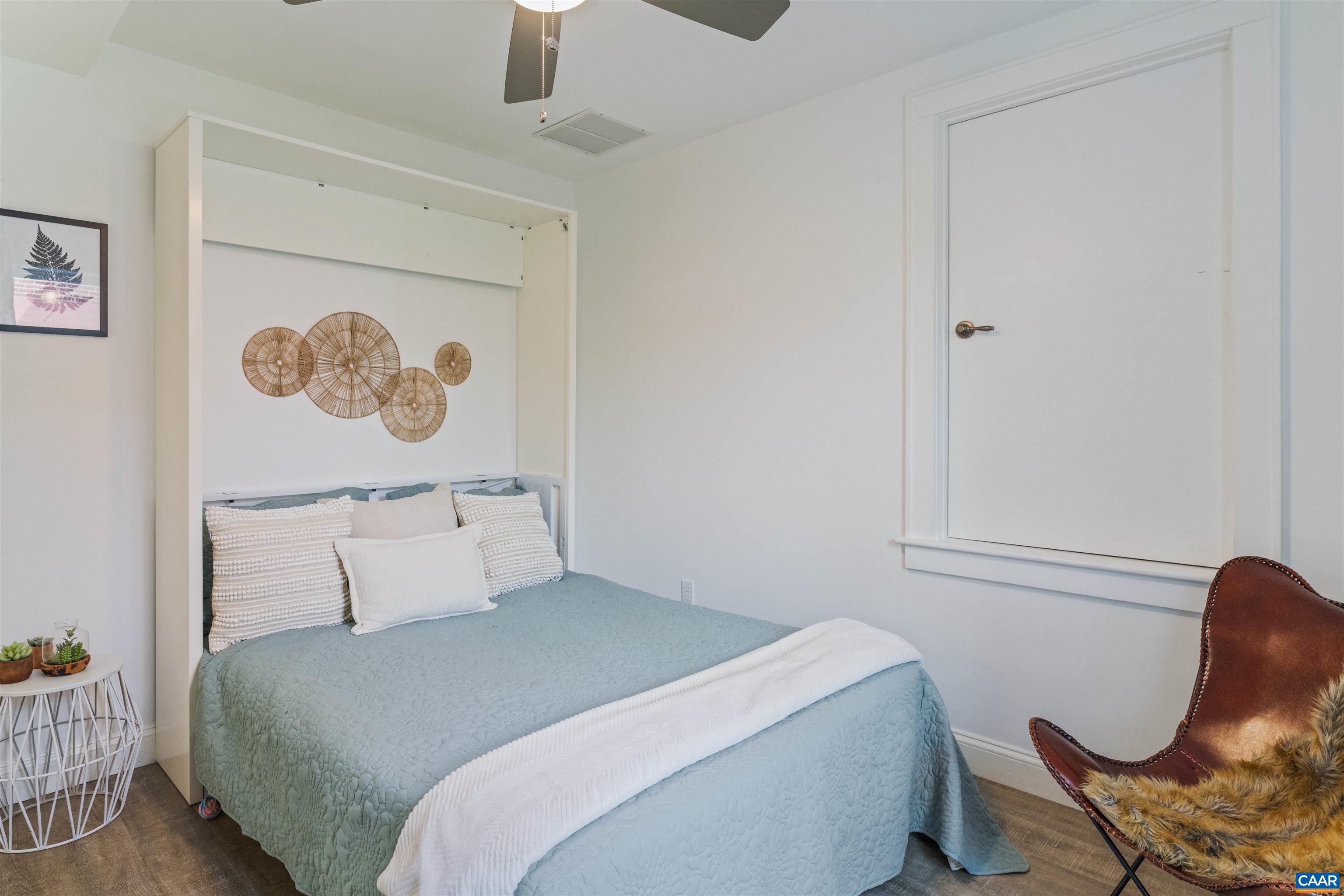 738 Lexington Avenue Charlottesville, VA 22902 - Photo 23 of 34 a bedroom with a bed and chair