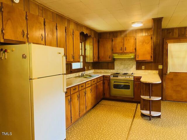 480 Peed Road Rougemont, NC 27572 - Photo 15 of 38 a kitchen with a sink a stove cabinets and a refrigerator
