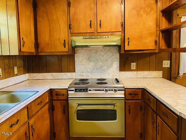 480 Peed Road Rougemont, NC 27572 - Photo 31 of 38 a kitchen with stainless steel appliances granite countertop a stove and a sink