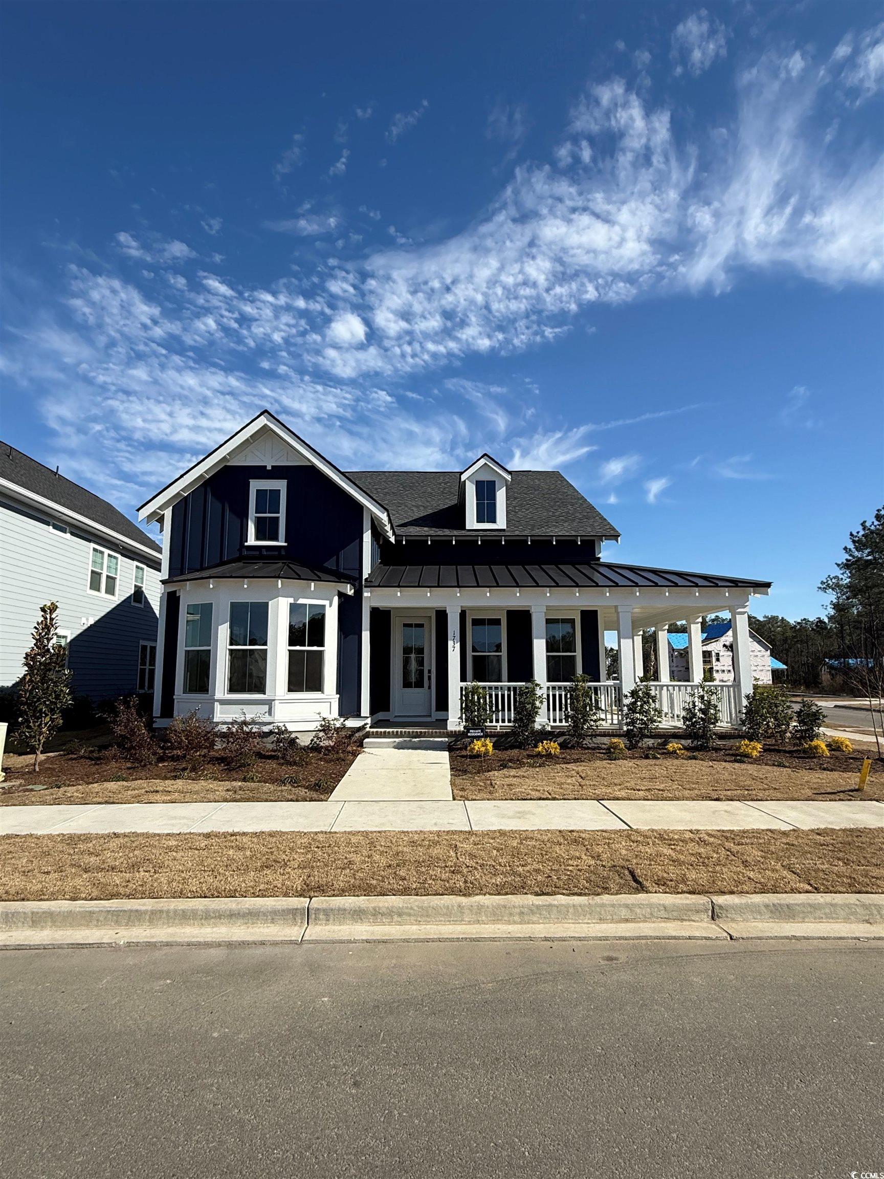 1737 Tryon Drive Myrtle Beach, SC 29588 - Photo 1 of 1 View of front of property featuring a porch, a shingled roof, a standing seam roof, and a metal roof