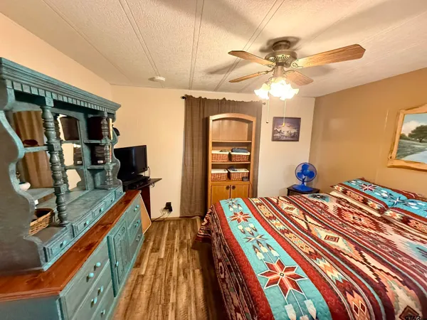 a bedroom with a bed and a chandelier