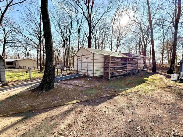 a view of a house with a yard covered in snow