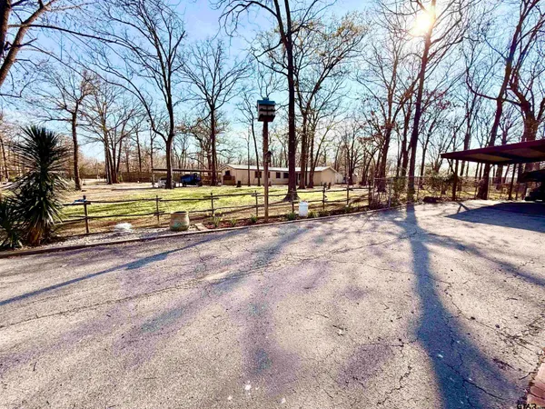 a view of yard with tree and wooden fence
