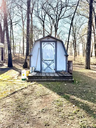 a view of a house with a yard covered in snow