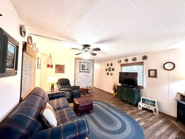 a living room with furniture a fireplace and a flat screen tv