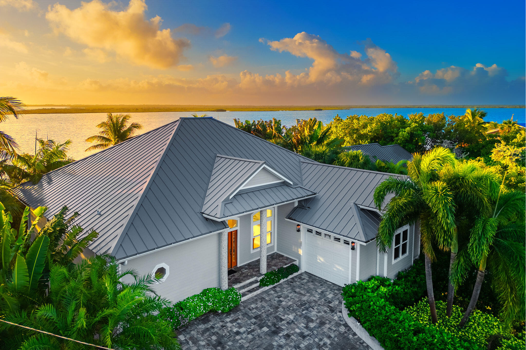 a aerial view of a house with a yard and potted plants