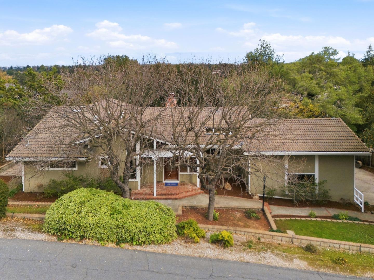 10140 Hillcrest Road Cupertino, CA 95014 - Photo 1 of 39 a view of a patio with a table and chairs under an umbrella