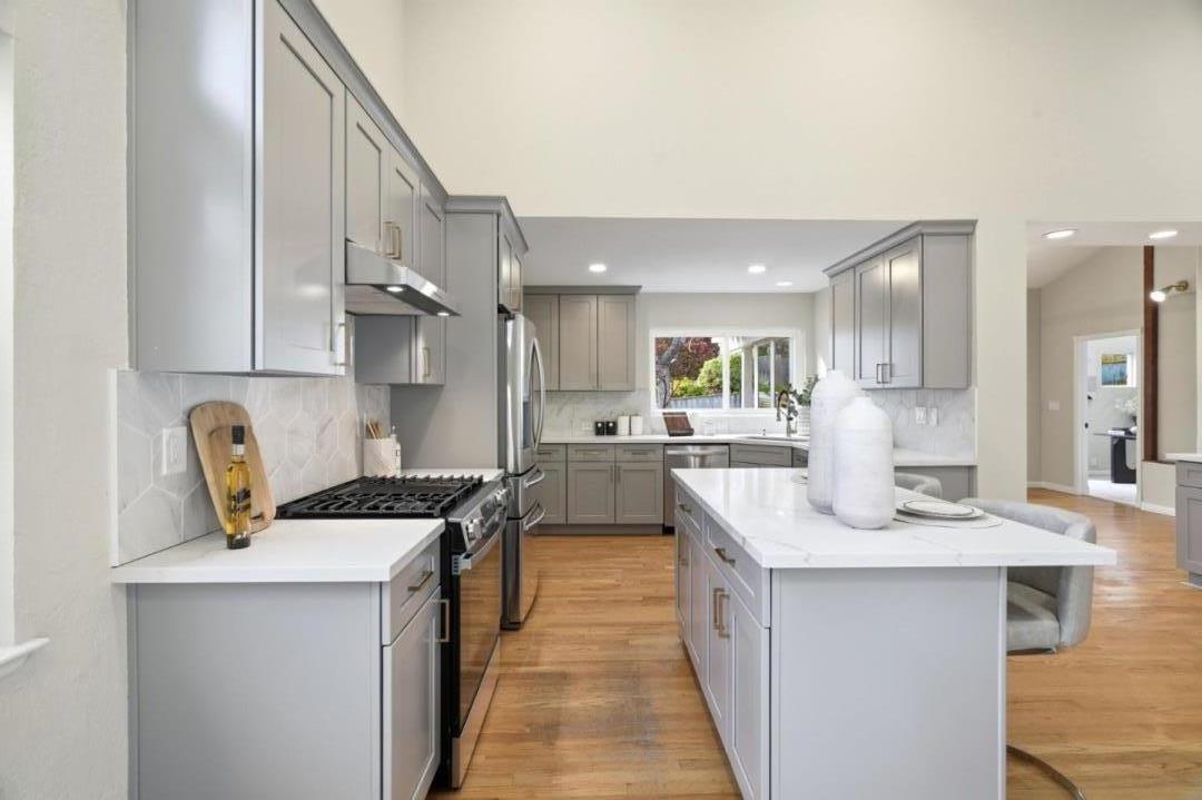 10140 Hillcrest Road Cupertino, CA 95014 - Photo 12 of 39 a kitchen with kitchen island a counter top space a sink stainless steel appliances and cabinets