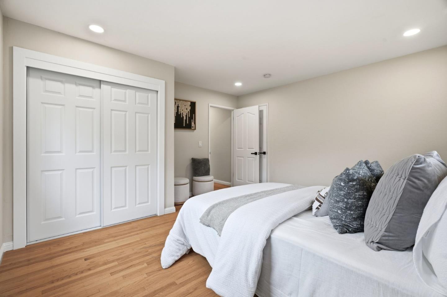 10140 Hillcrest Road Cupertino, CA 95014 - Photo 17 of 39 a spacious bedroom with a bed and a wooden floor