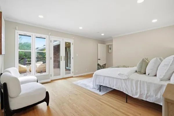 a bedroom with a bed and glass window