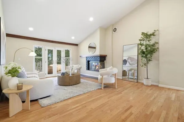 a living room with fireplace furniture and a wooden floor