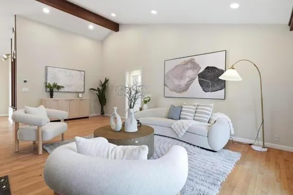 a living room with furniture and wooden floor