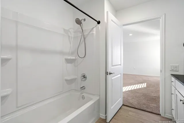 a bathroom with a bathtub and a shower