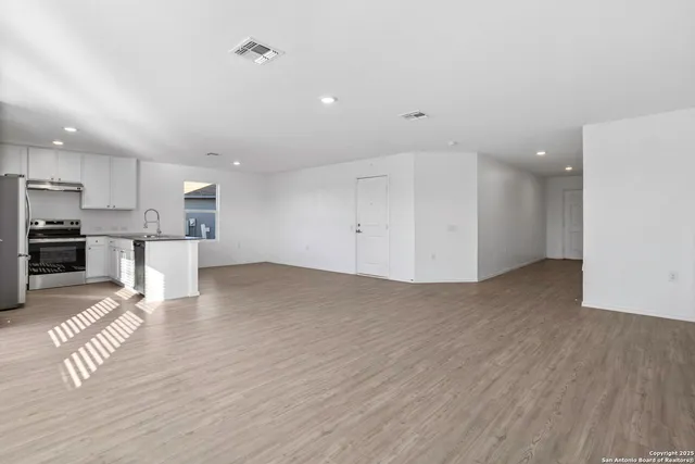 a view of kitchen with furniture and wooden floor