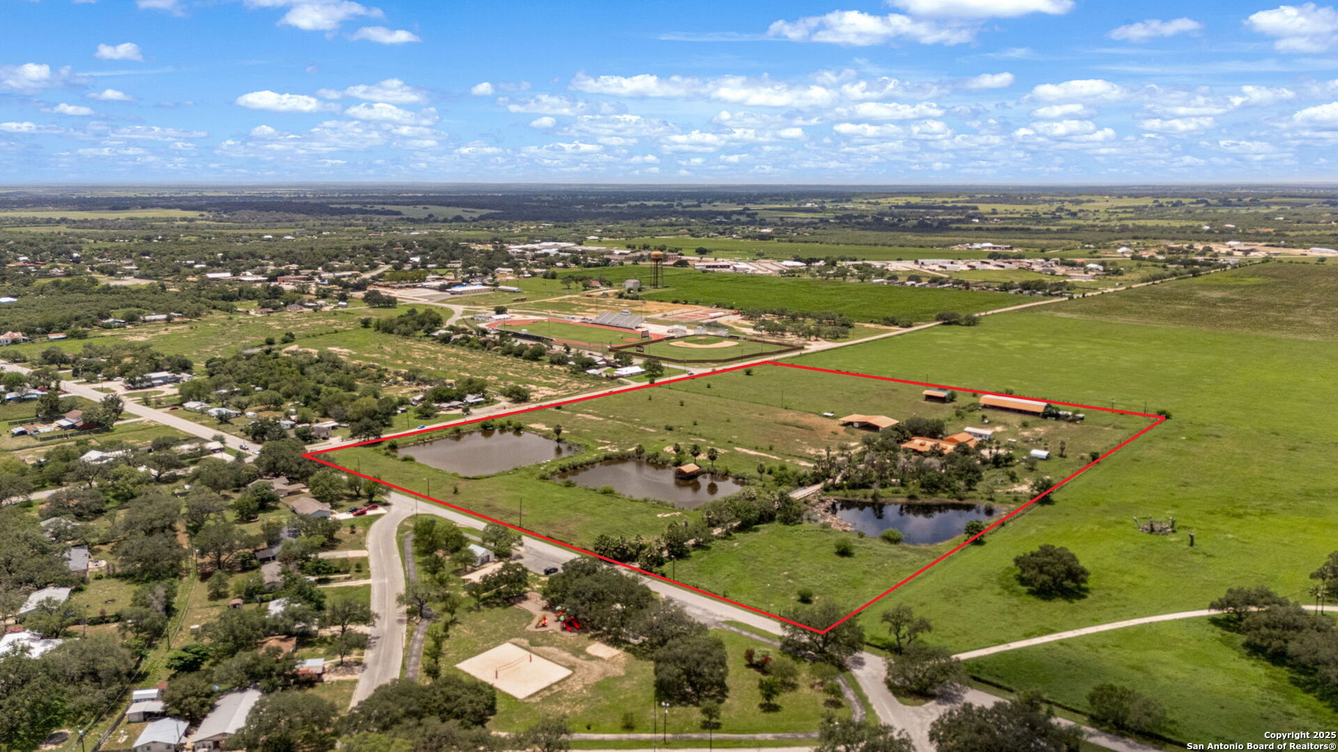 1551 North Windy Knoll Drive Devine, TX 78016 - Photo 1 of 42 an aerial view of ocean and residential houses with outdoor space