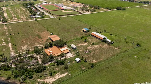 an aerial view of a house with a yard