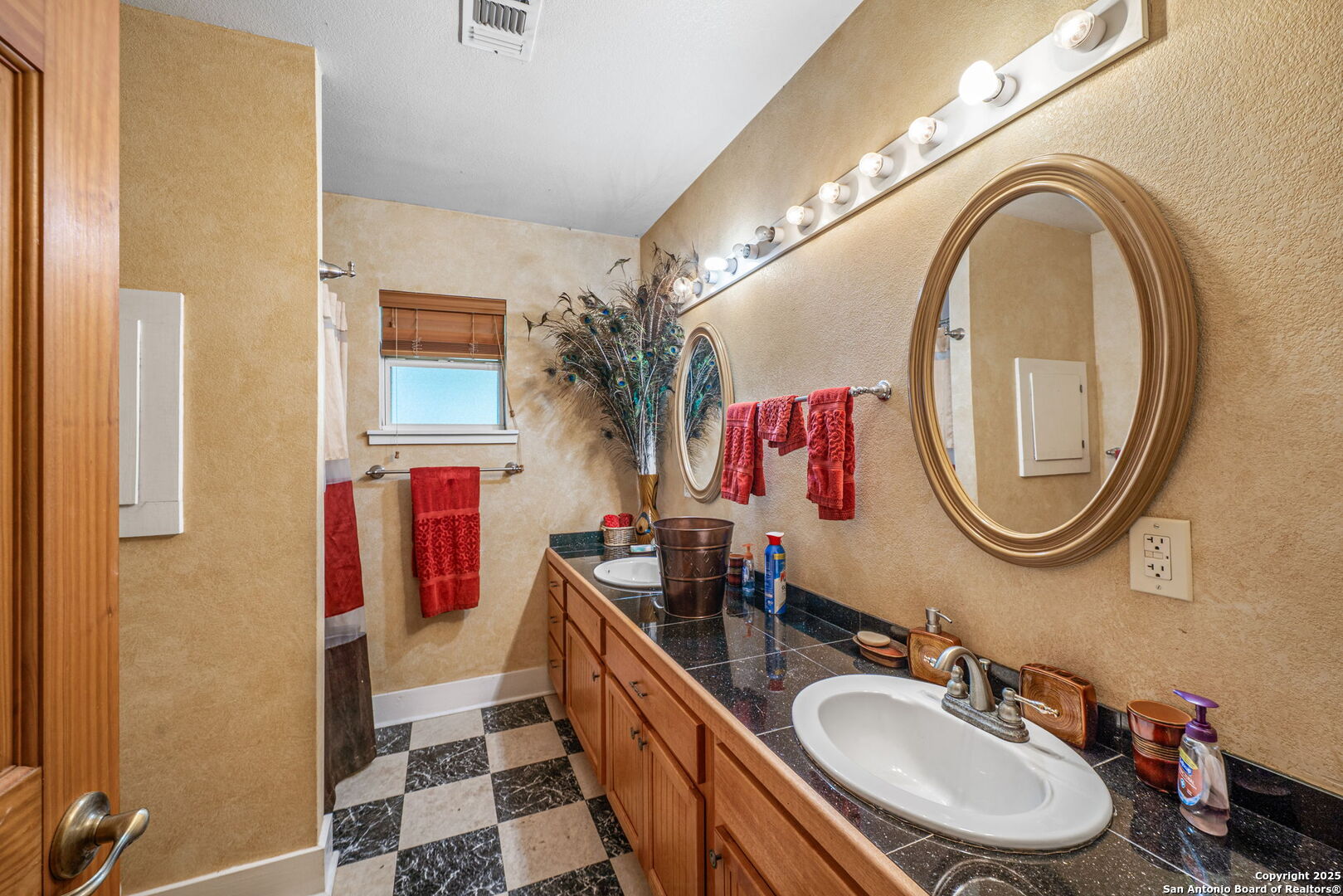 1551 North Windy Knoll Drive Devine, TX 78016 - Photo 32 of 42 a bathroom with a double vanity sink and a mirror