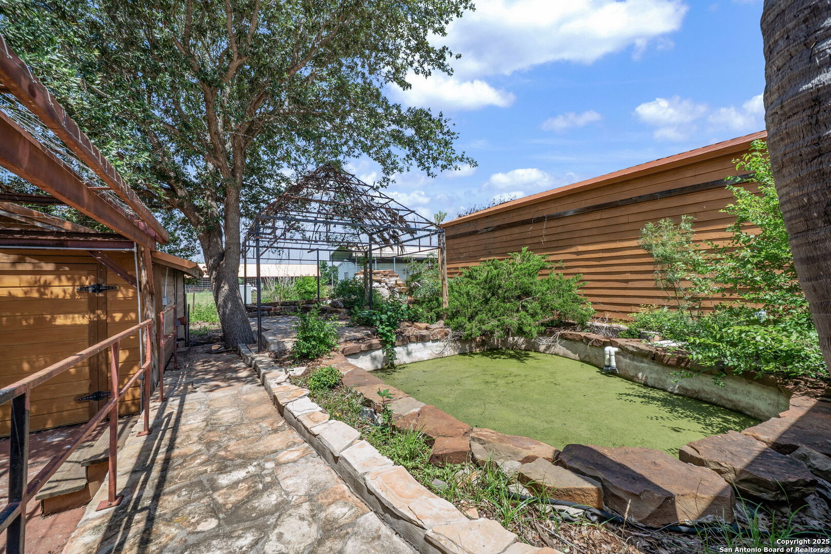 1551 North Windy Knoll Drive Devine, TX 78016 - Photo 33 of 42 a view of house with backyard outdoor seating and hardwood