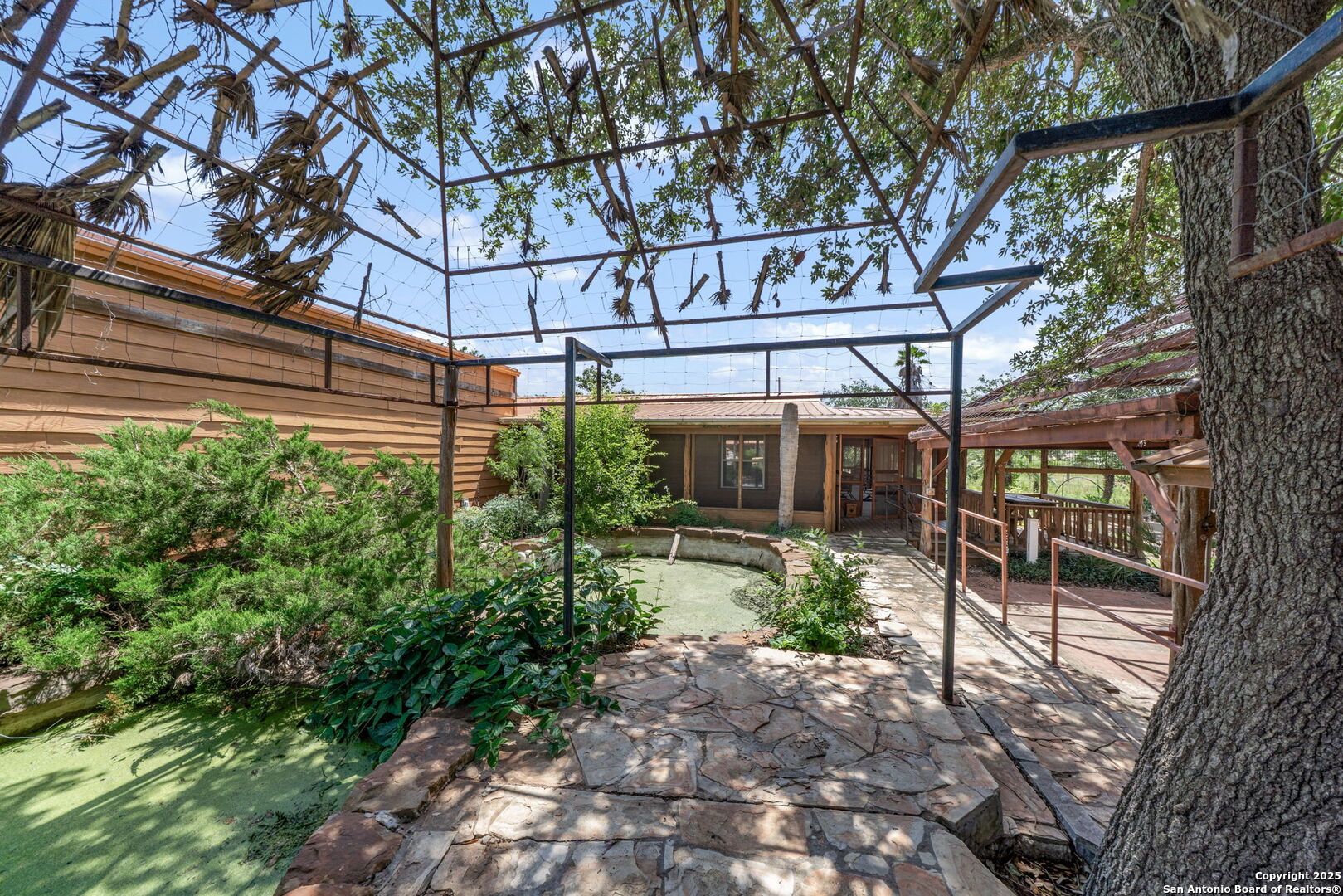 1551 North Windy Knoll Drive Devine, TX 78016 - Photo 35 of 42 a view of a building with a tree