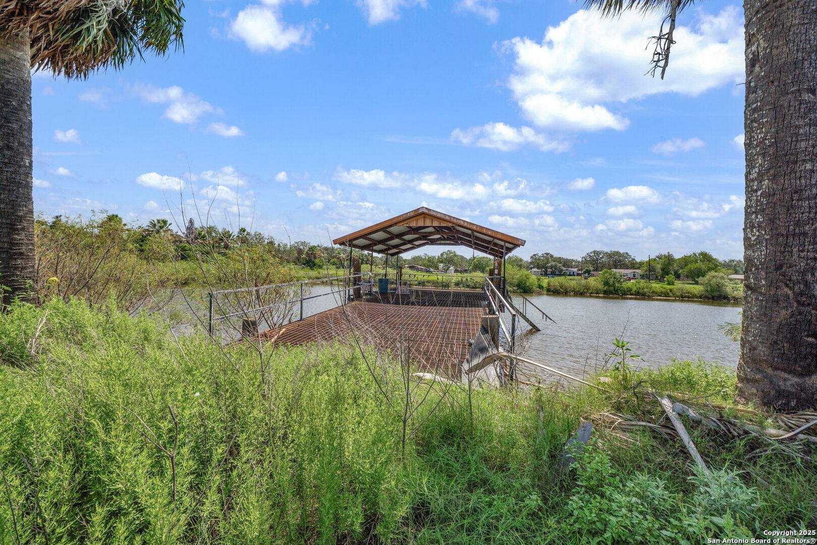 1551 North Windy Knoll Drive Devine, TX 78016 - Photo 39 of 42 a view of a lake from a yard