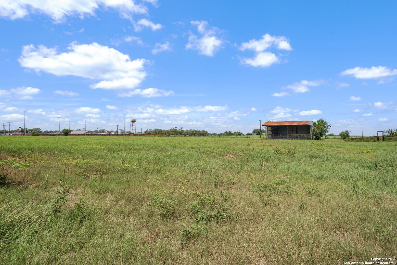 1551 North Windy Knoll Drive Devine, TX 78016 - Photo 40 of 42 a view of a big yard with table and chairs and a fire pit