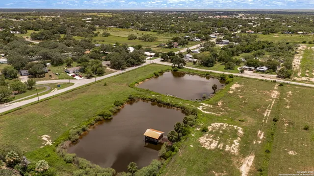 an aerial view of a houses with a lake view