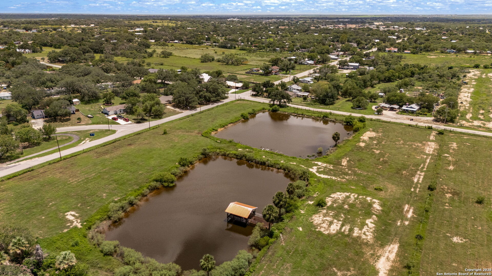 1551 North Windy Knoll Drive Devine, TX 78016 - Photo 5 of 42 an aerial view of residential houses with outdoor space