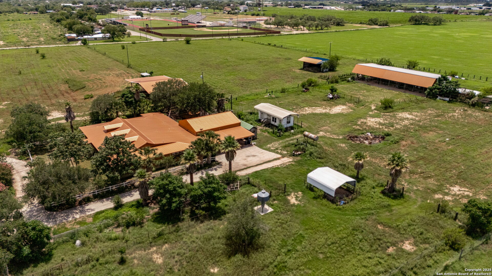 1551 North Windy Knoll Drive Devine, TX 78016 - Photo 9 of 42 an aerial view of a houses with outdoor space and lake view
