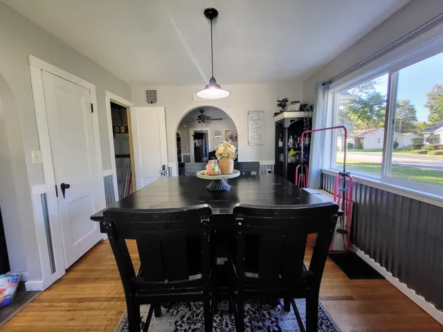 a view of a dining room with furniture window and wooden floor