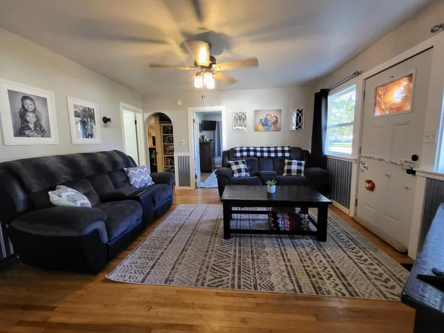 a living room with furniture and wooden floor