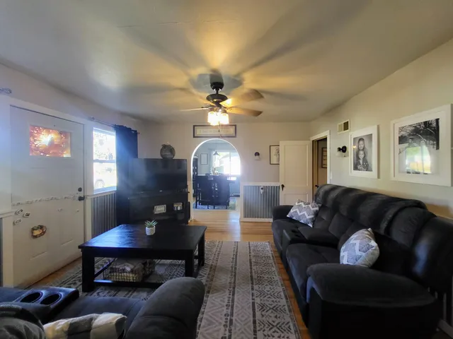 a living room with furniture and a chandelier