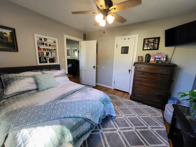 a bedroom with a bed and a television