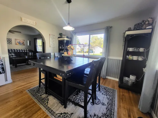 a view of a dining room with furniture window and wooden floor