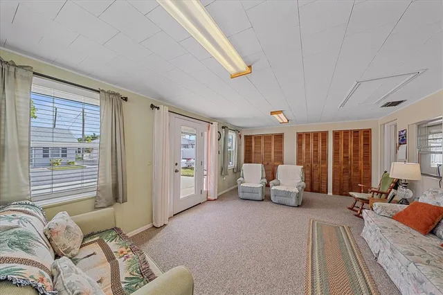 a bedroom with furniture and a large window