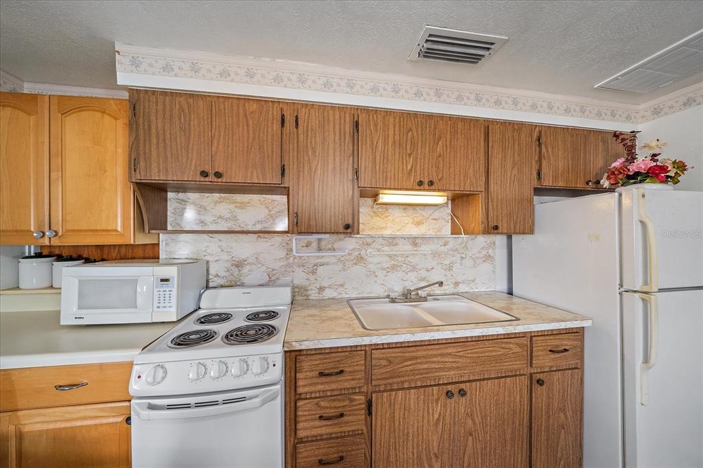 1260 Yoder Avenue Sarasota, FL 34239 - Photo 23 of 42 a kitchen with a sink stove and refrigerator
