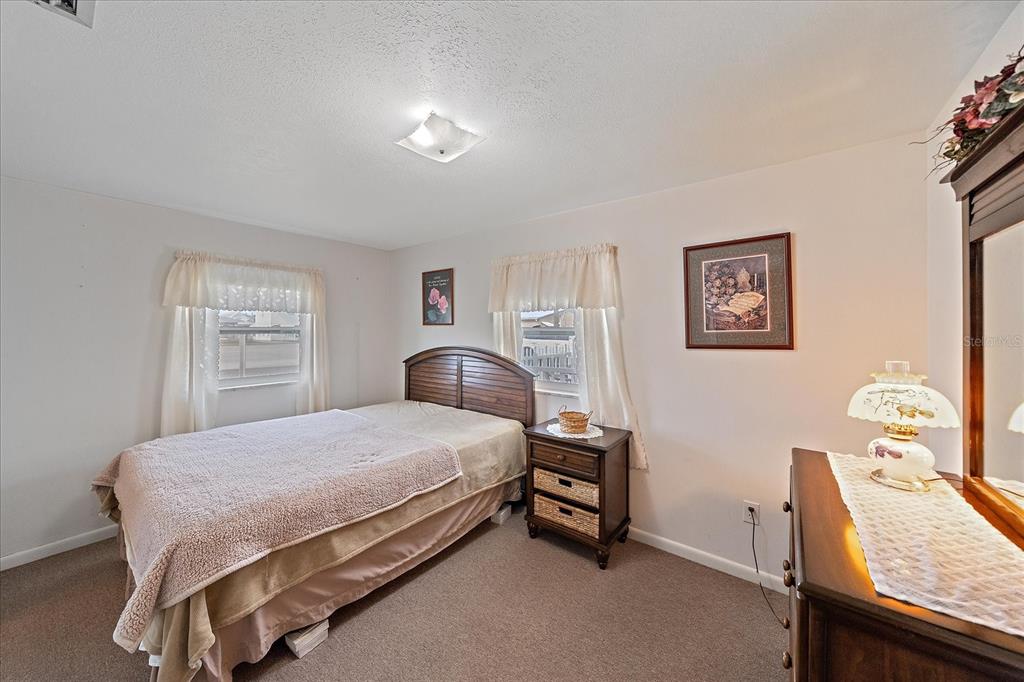 1260 Yoder Avenue Sarasota, FL 34239 - Photo 28 of 42 a bedroom with a bed and a table in it