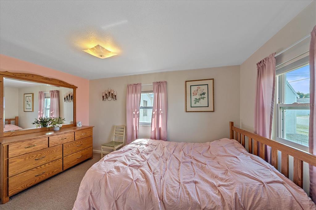 1260 Yoder Avenue Sarasota, FL 34239 - Photo 31 of 42 a bedroom with a bed and a chandelier