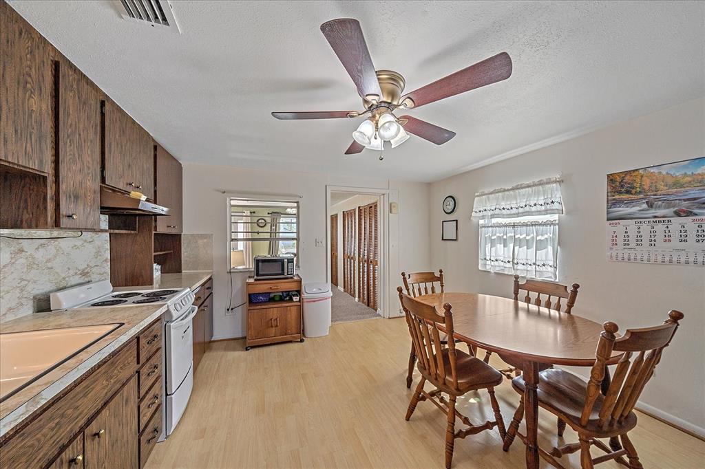 1260 Yoder Avenue Sarasota, FL 34239 - Photo 33 of 42 a view of a dining room with furniture window and wooden floor