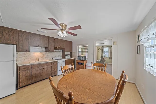 a dining room with furniture and window